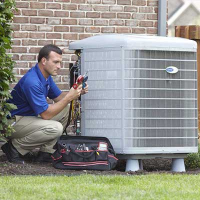Worker inspecting a residential HVAC unit